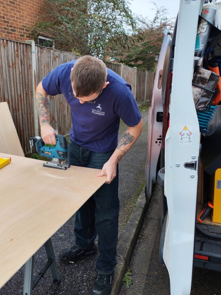 The Bedfordshire Plumber preparing materials from work van